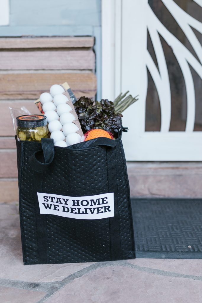 bag of groceries in reusable bag on front porch